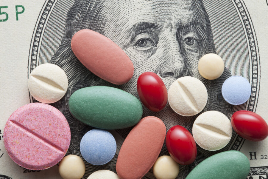 Pills on US dollars indicating this money was a seizure from proceeds of illegal drug sales.